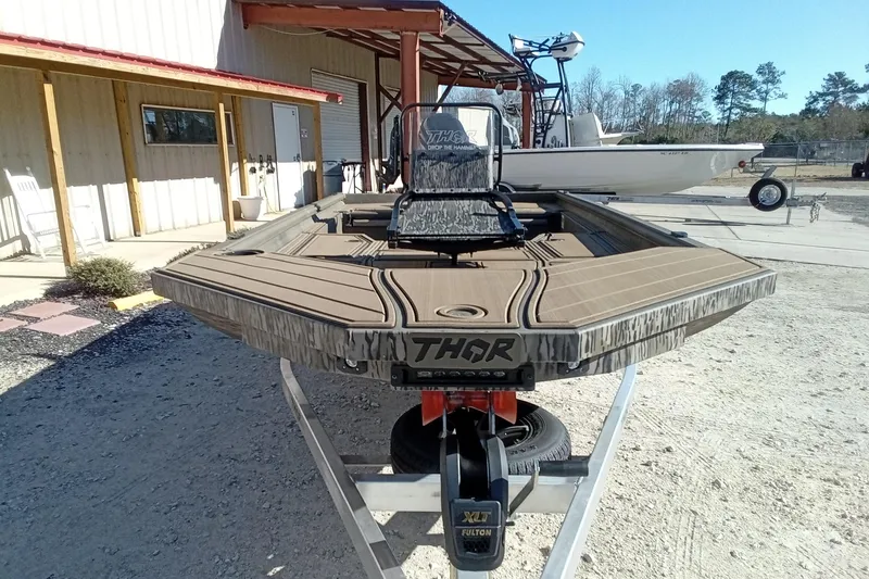 Slide: The Image of 2026 Thor 1900 Lake Hammer boat on trailer outside a building. - 7