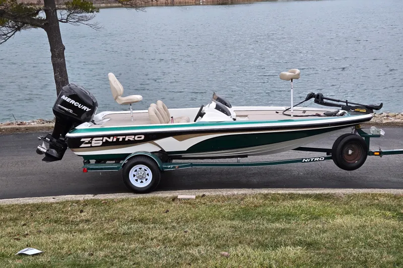 The Image of 2008 Nitro Z-6 boat with Mercury engine on trailer by a lake. - 0