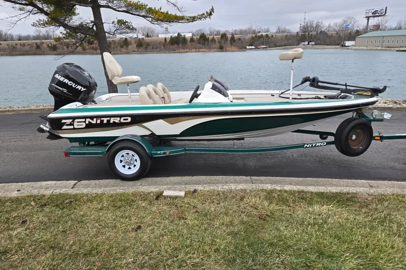 Slide: The Image of 2008 Nitro Z-6 boat with Mercury engine on trailer by a lake. - 10