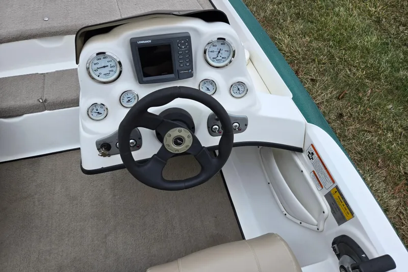 Slide: The Image of 2008 Nitro Z-6 boat dashboard with steering wheel and gauges. - 12