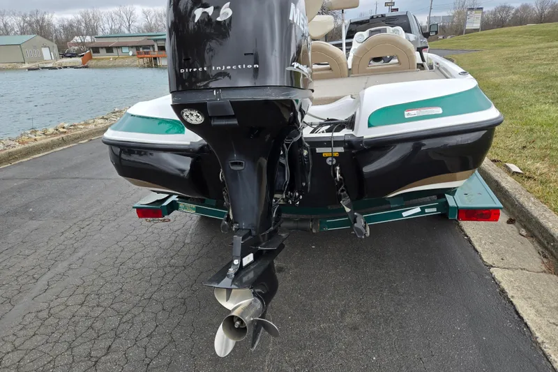 Slide: The Image of 2008 Nitro Z-6 boat on trailer by a lakeside road. - 2