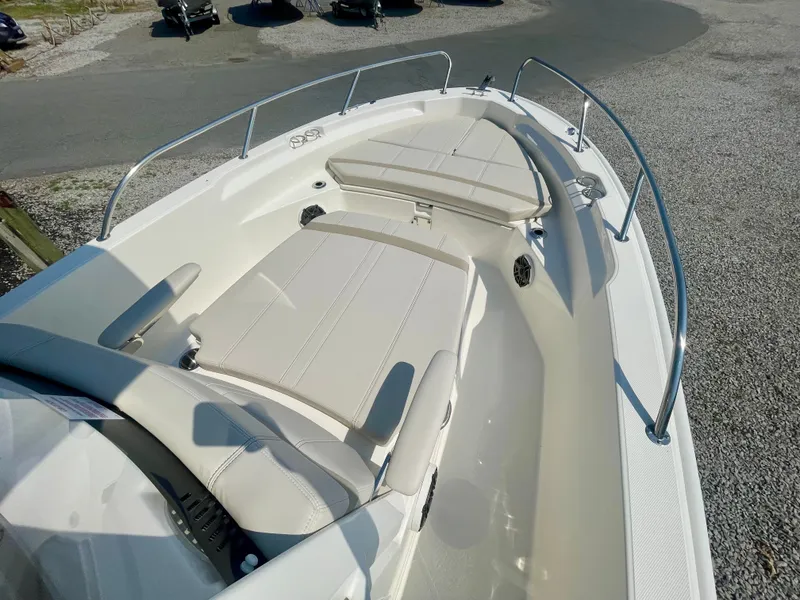 Slide: The Image of The image shows the bow of a Boston Whaler 220 Dauntless boat with beige cushions. - 14