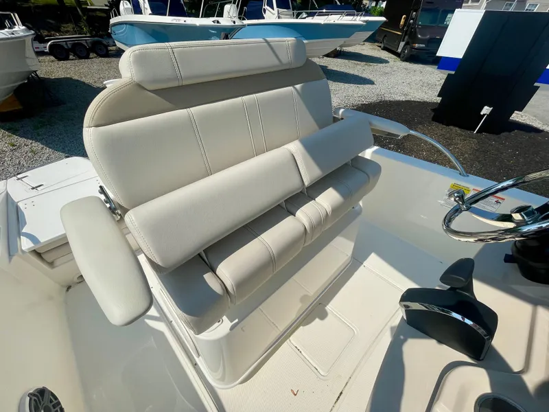 Slide: The Image of The image shows a beige bench seat on a boat, surrounded by other boats outdoors. - 8