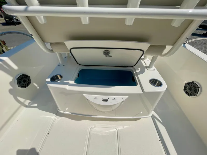Slide: The Image of The image shows the rear area of a Boston Whaler 220 Dauntless boat with an open storage compartment. - 5