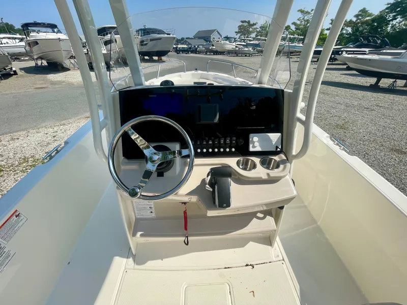 Slide: The Image of The image shows the helm of a Boston Whaler 220 Dauntless boat with steering wheel and instruments. - 10