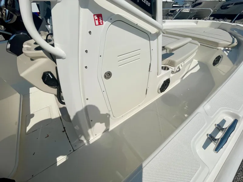 Slide: The Image of The image shows the cockpit of a Boston Whaler 220 Dauntless with a bench seat and helm console. - 12