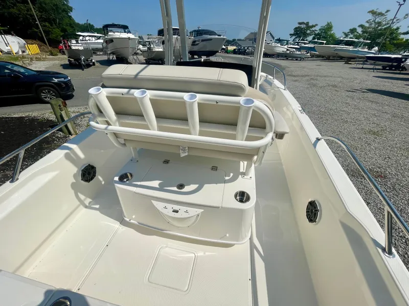 Slide: The Image of The image shows the cockpit of a Boston Whaler 220 Dauntless with a bench seat and rod holders. - 4