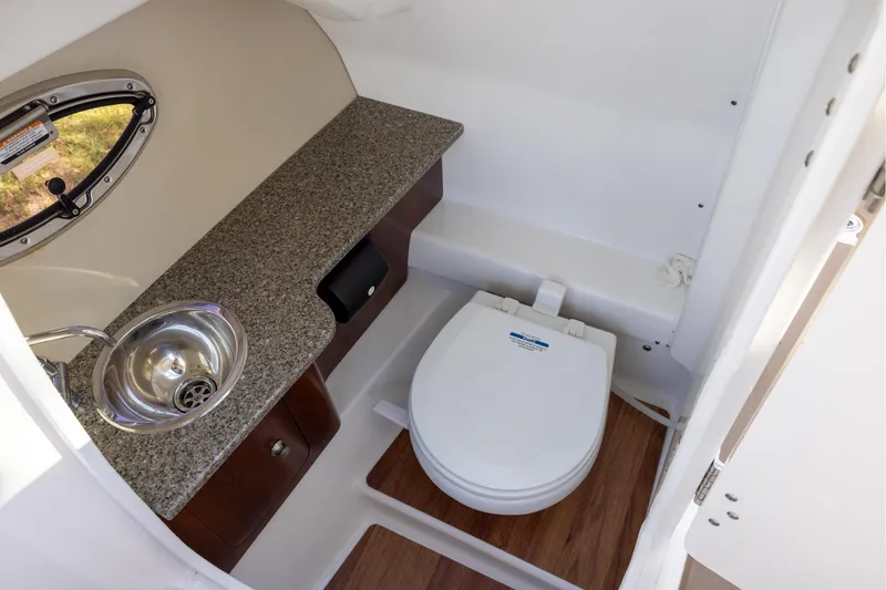 Slide: The Image of 2018 Chaparral 264 Sunesta boat bathroom with sink and toilet. - 10