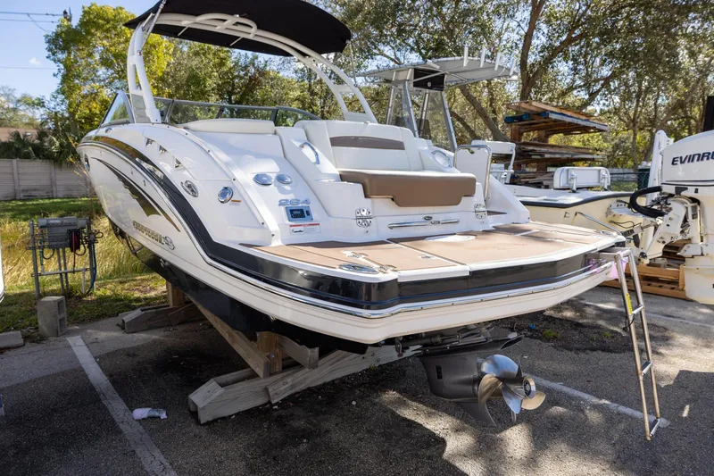 Slide: The Image of 2018 Chaparral 264 Sunesta boat on display, rear view with swim platform. - 2