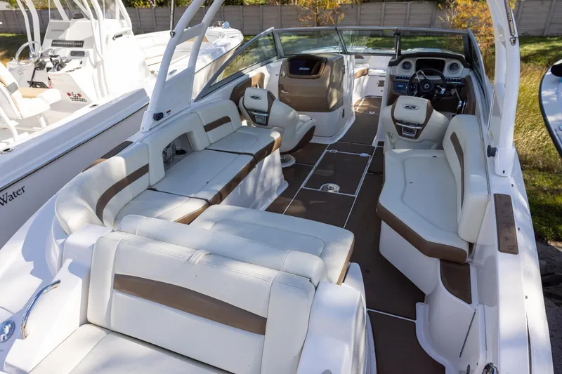 Slide: The Image of 2018 Chaparral 264 Sunesta boat interior with white and brown seating. - 4