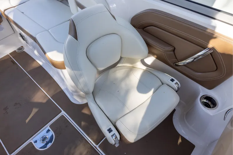 Slide: The Image of 2018 Chaparral 264 Sunesta boat interior with white and brown seating. - 9