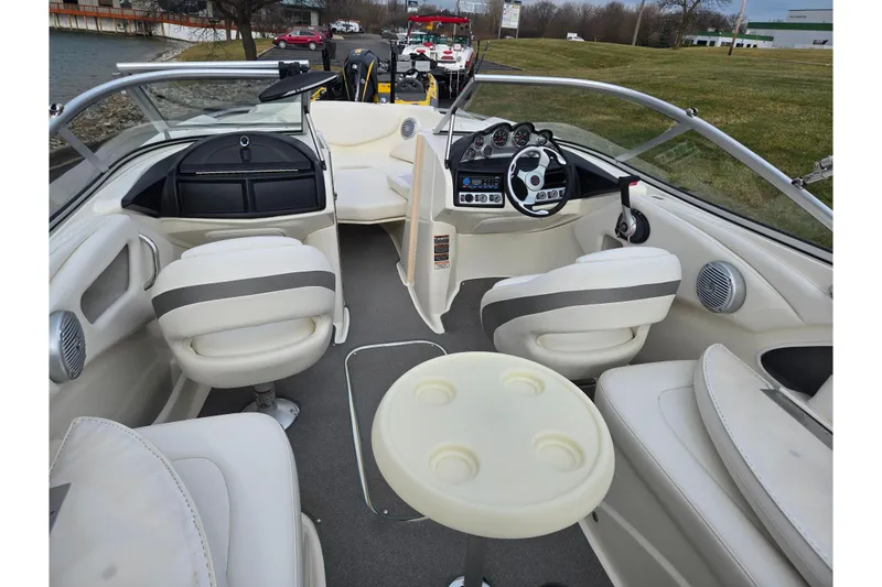 Slide: The Image of Interior of a 2009 Bayliner 225 boat with seating and steering wheel. - 11