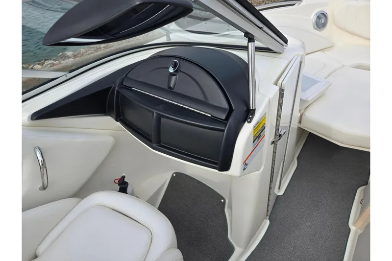Slide: The Image of 2009 Bayliner 225 boat interior with seating and storage compartment. - 15