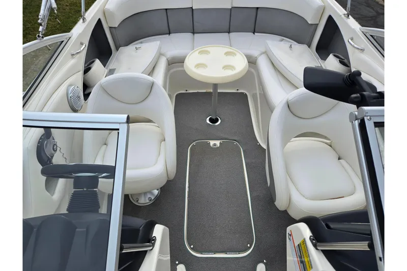 Slide: The Image of Interior of a 2009 Bayliner 225 boat with seating and table. - 21