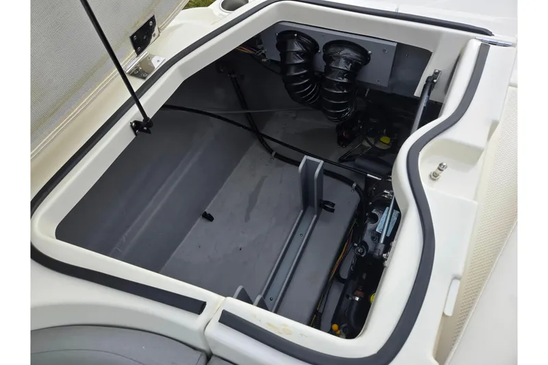 Slide: The Image of Open engine compartment of 2009 Bayliner 225 boat, showcasing internal components. - 24
