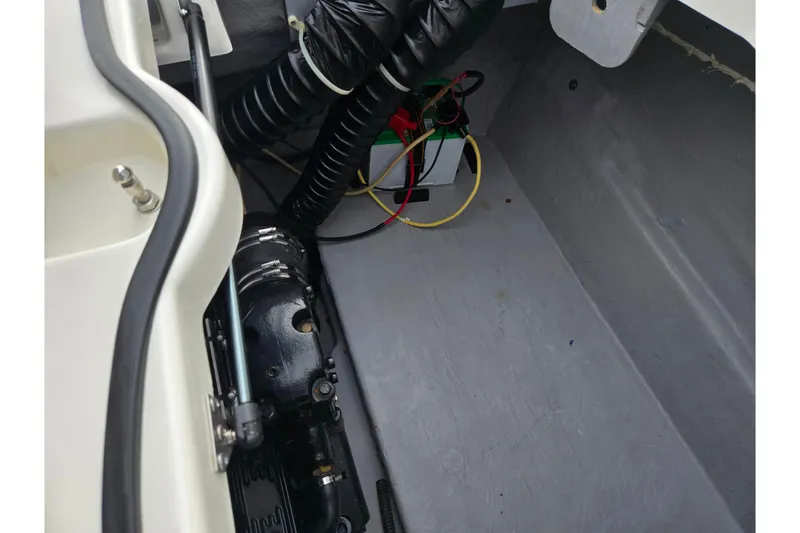 Slide: The Image of 2009 Bayliner 225 engine compartment with visible wiring and components. - 25