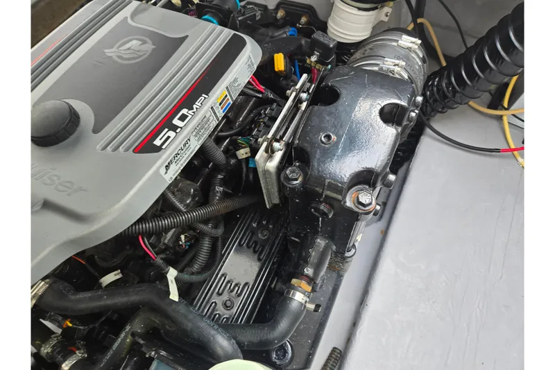 Slide: The Image of Engine of 2009 Bayliner 225 boat, featuring a 5.0 MPI Mercury motor. - 26