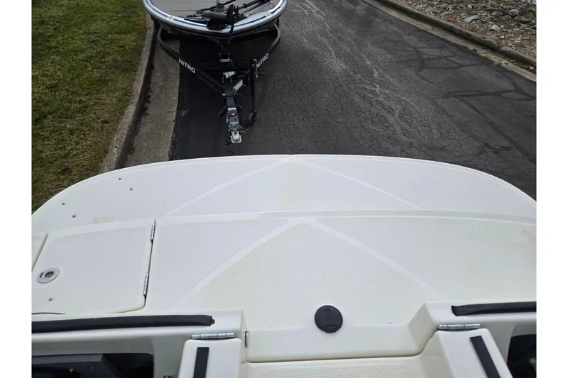 Slide: The Image of 2009 Bayliner 225 boat on trailer, parked on a paved road. - 27