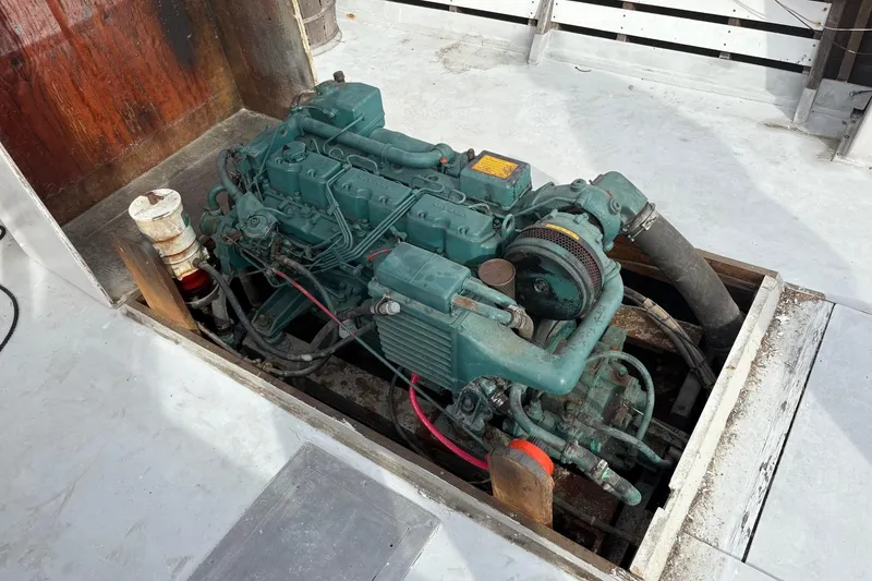 Slide: The Image of Engine compartment of a 1979 Custom Chesapeake Sportfish Cruiser, showcasing marine engine details. - 8