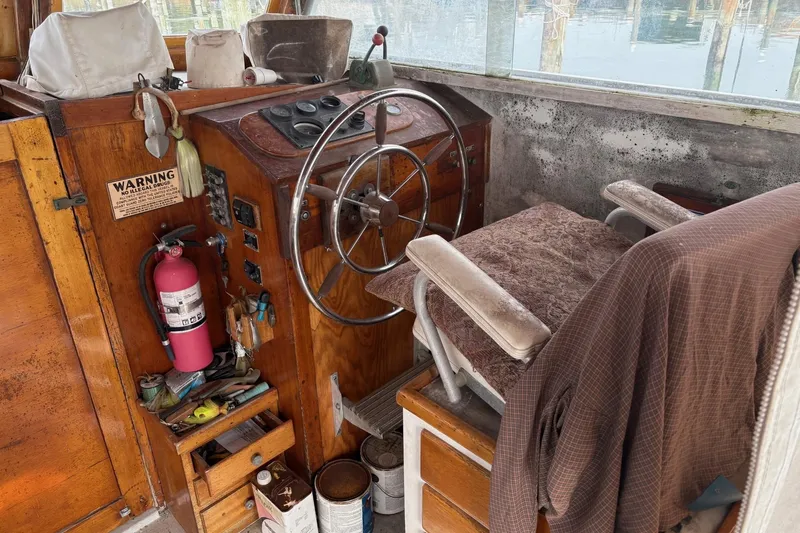 Slide: The Image of 1979 Custom Chesapeake Sportfish Cruiser interior with steering wheel, gauges, and fire extinguisher. - 9