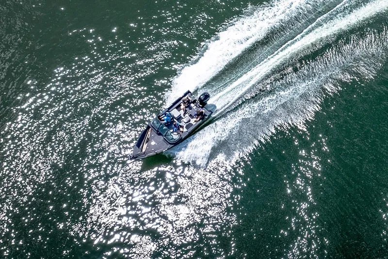 Slide: The Image of 2026 Lund 1775 Impact XS Sport boat dashboard with audio controls and textured finish. - 11