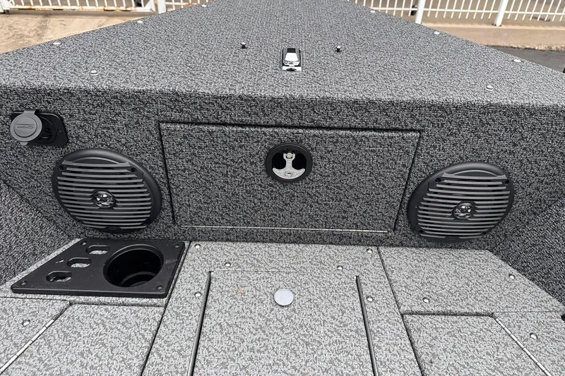 Slide: The Image of 2026 Lund 1775 Impact XS Sport boat interior with speakers and storage compartment. - 15