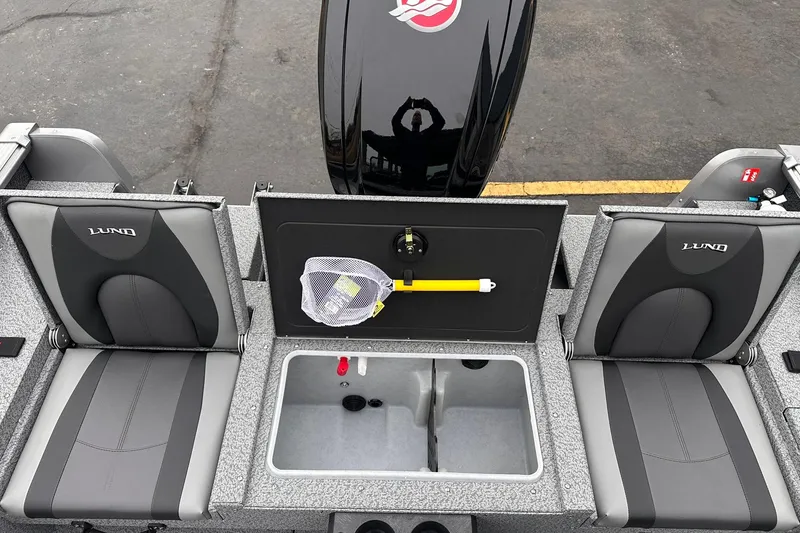 Slide: The Image of 2026 Lund 1775 Impact XS Sport boat interior with seating and storage compartments. - 16