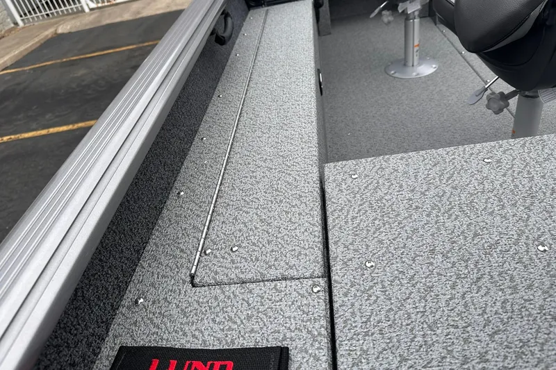 Slide: The Image of 2026 Lund 1775 Impact XS Sport boat interior with textured flooring and seating. - 20