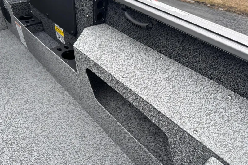 Slide: The Image of 2026 Lund 1775 Impact XS Sport boat interior with textured flooring and storage compartments. - 22
