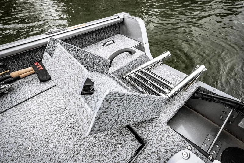 Slide: The Image of 2026 Lund 1775 Impact XS Sport boat interior with seating and steering console. - 4