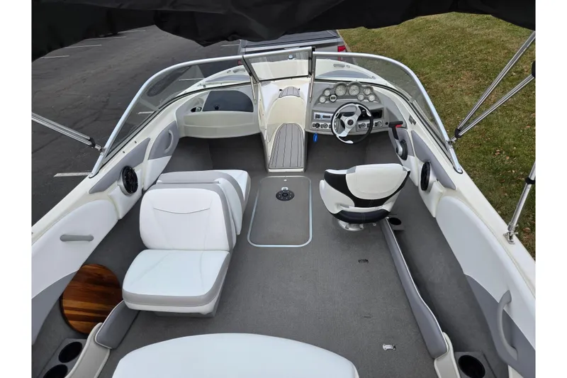 Slide: The Image of Interior of a 2010 Bayliner 185 boat with seating and steering wheel. - 10