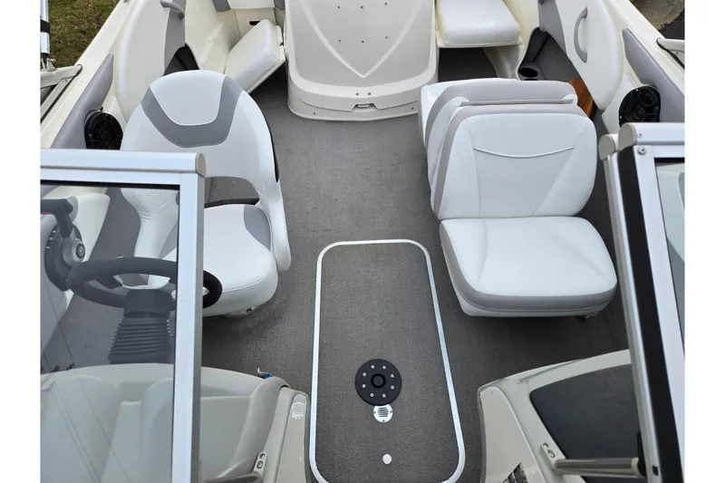 Slide: The Image of 2010 Bayliner 185 boat interior with white seating and steering wheel. - 20
