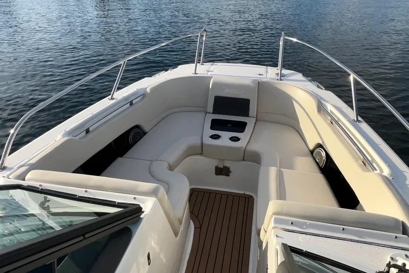 Slide: The Image of 2019 Boston Whaler 270 Vantage boat interior with cushioned seating and cup holders. - 15