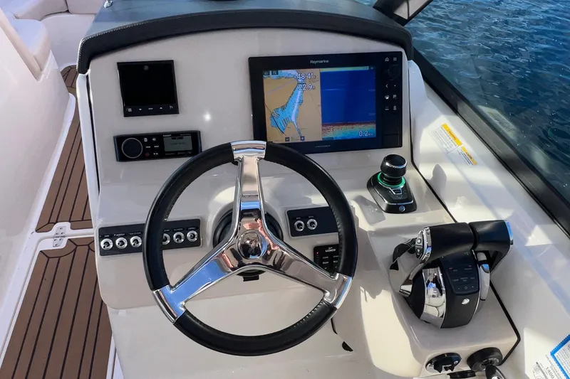 Slide: The Image of 2019 Boston Whaler 270 Vantage helm with navigation display and controls. - 16