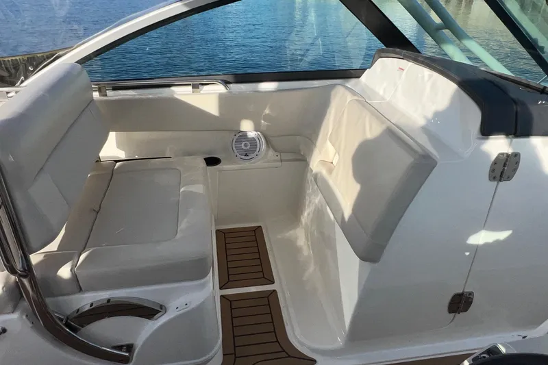 Slide: The Image of 2019 Boston Whaler 270 Vantage interior with cushioned seating and wood accents. - 20