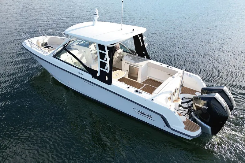 Slide: The Image of 2019 Boston Whaler 270 Vantage boat on calm water, featuring dual Mercury engines. - 3