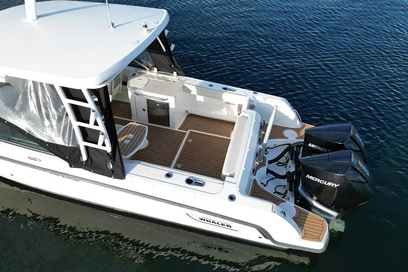 Slide: The Image of 2019 Boston Whaler 270 Vantage boat with twin Mercury engines on water. - 6