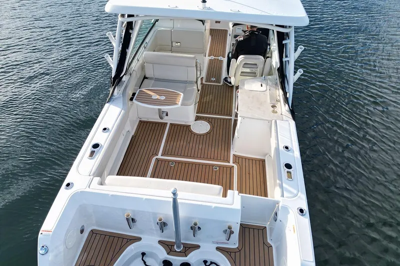 Slide: The Image of 2019 Boston Whaler 270 Vantage boat with spacious deck and seating on water. - 7