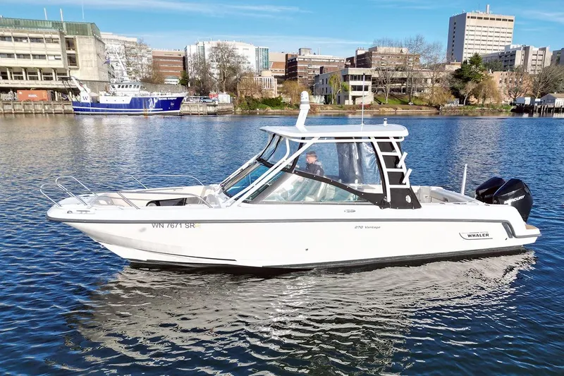 Slide: The Image of 2019 Boston Whaler 270 Vantage boat on urban waterway, cityscape background. - 9
