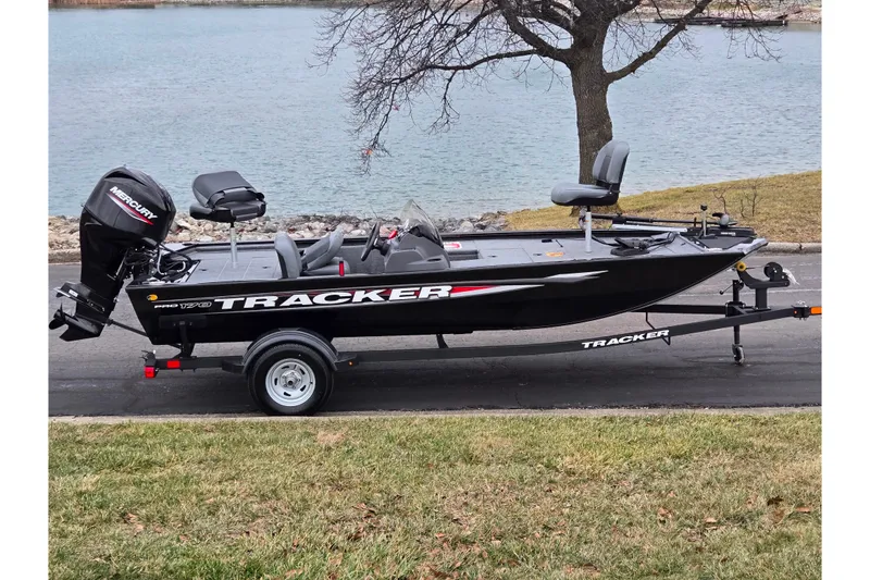 The Image of 2025 Tracker Pro 170 fishing boat on trailer by a lake. - 0