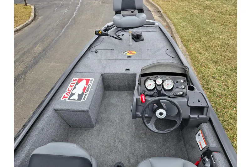 Slide: The Image of 2025 Tracker Pro 170 boat interior with steering console and seating, featuring Tackle Warehouse branding. - 11