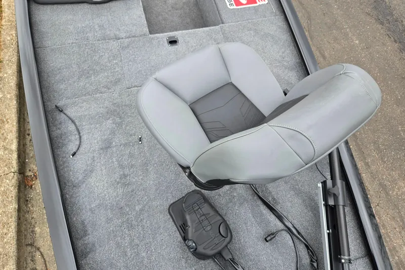 Slide: The Image of 2025 Tracker Pro 170 boat interior with gray seating and carpeted flooring. - 17