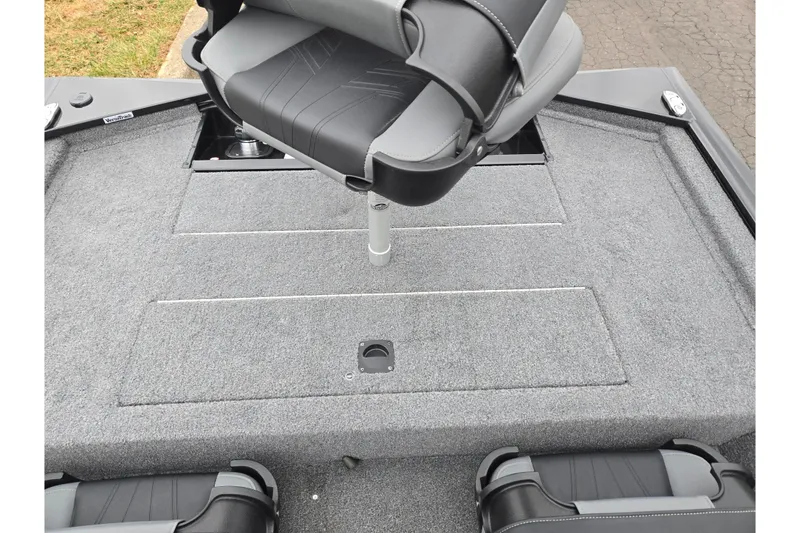 Slide: The Image of 2025 Tracker Pro 170 boat interior with gray carpet and swivel seat. - 21