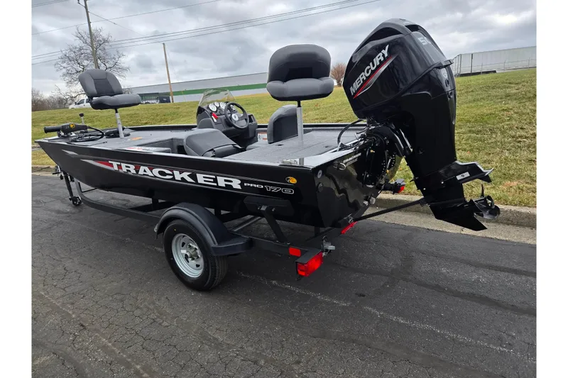 Slide: The Image of 2025 Tracker Pro 170 boat with Mercury engine on a trailer, parked outdoors. - 3