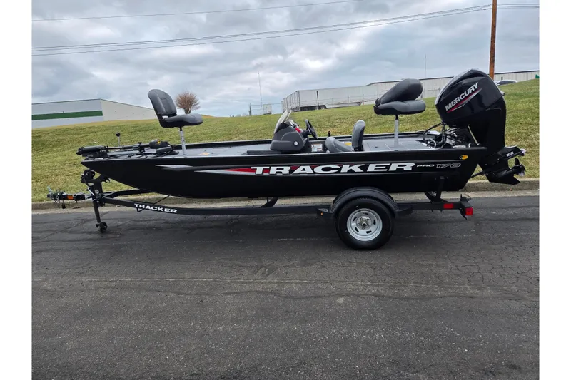 Slide: The Image of 2025 Tracker Pro 170 boat on trailer, parked outdoors under cloudy sky. - 4