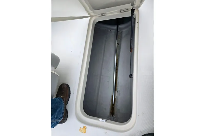 Slide: The Image of Open storage compartment in 2011 Bayliner 195 boat interior. - 13