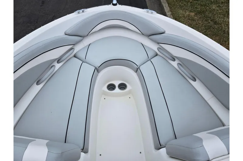 Slide: The Image of 2011 Bayliner 195 boat interior with gray cushioned seating. - 16