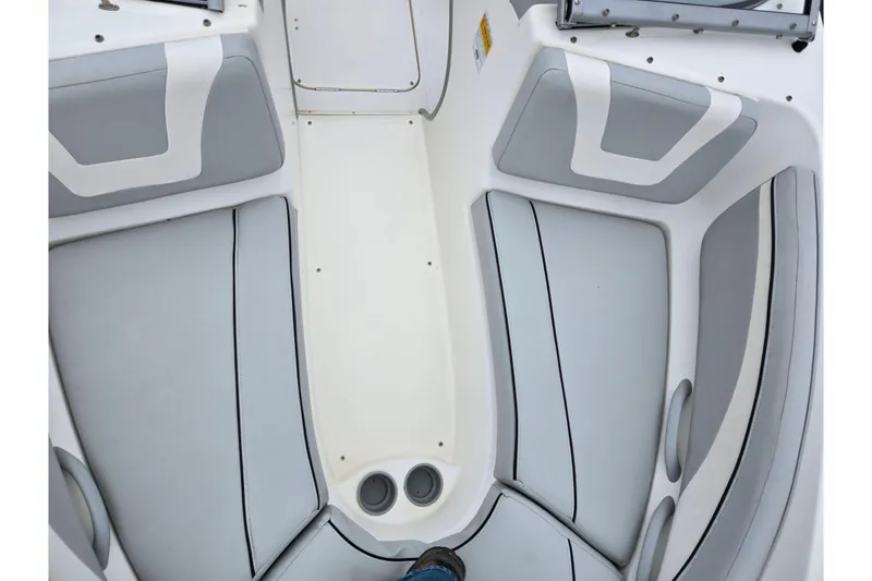 Slide: The Image of Interior view of a 2011 Bayliner 195 boat with gray seating. - 17