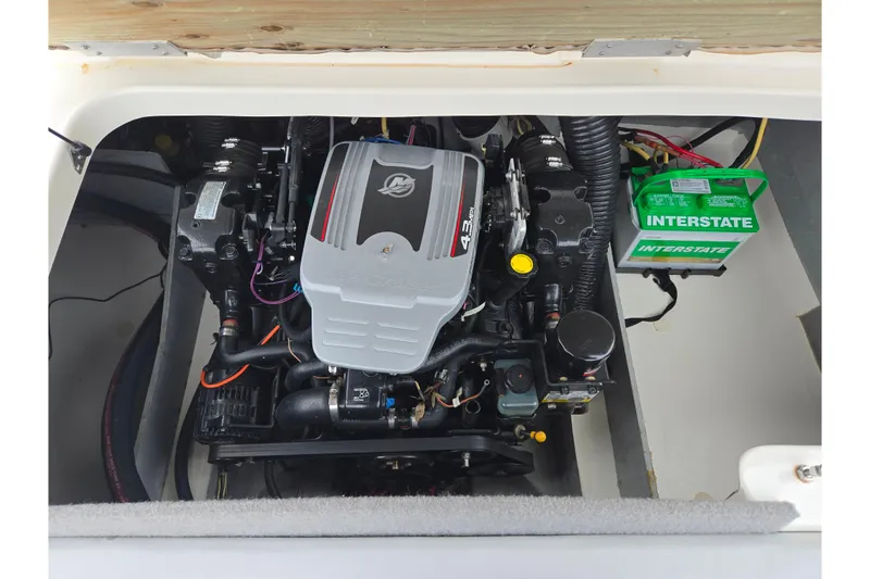 Slide: The Image of 2011 Bayliner 195 engine compartment with Interstate battery and 4.3L engine. - 21