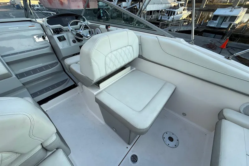 Slide: The Image of 2020 Regal 26 XO boat interior with white seating and steering wheel. - 12